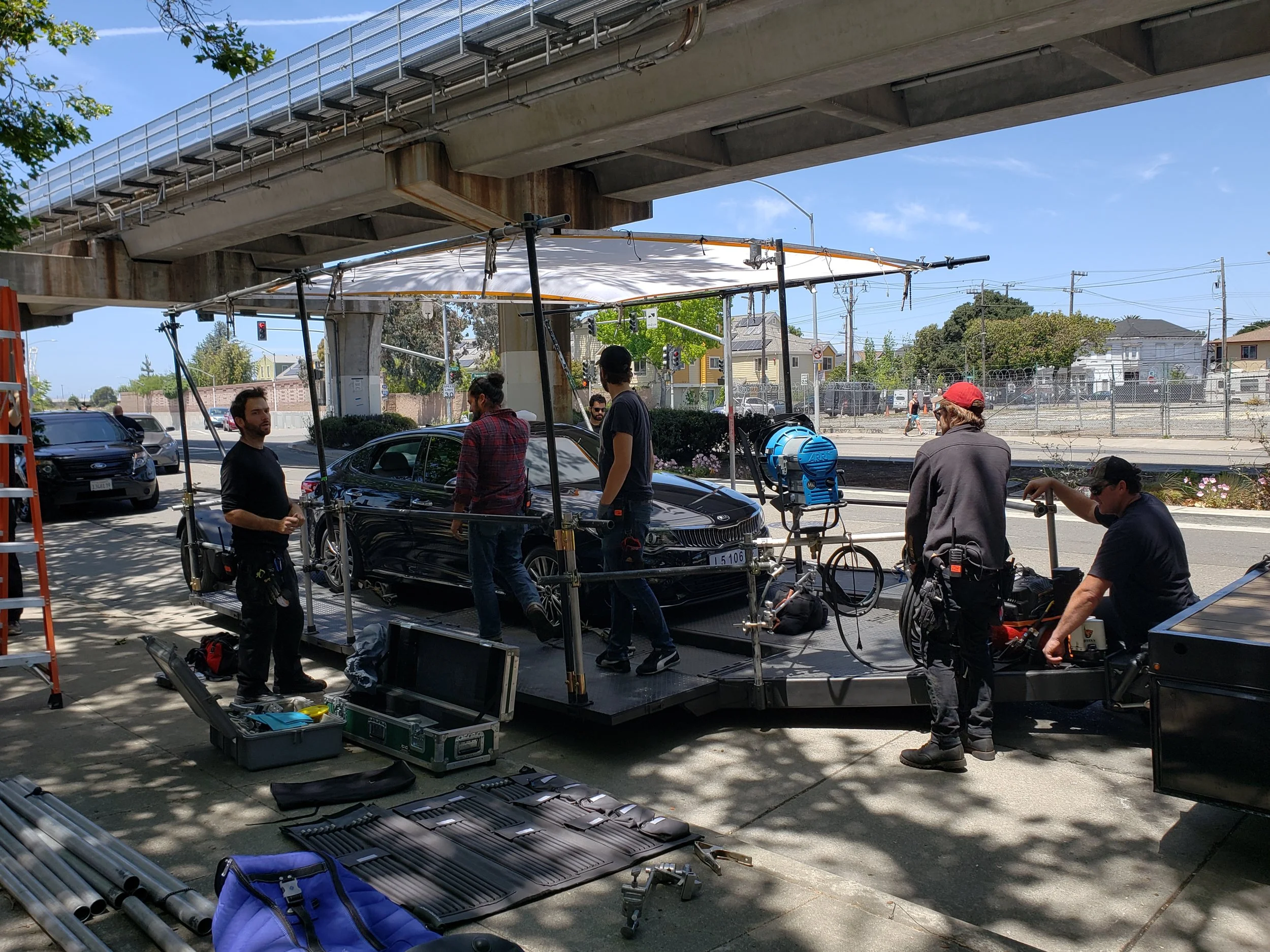 Camera car and crew filming a Kia sedan on a process trailer
